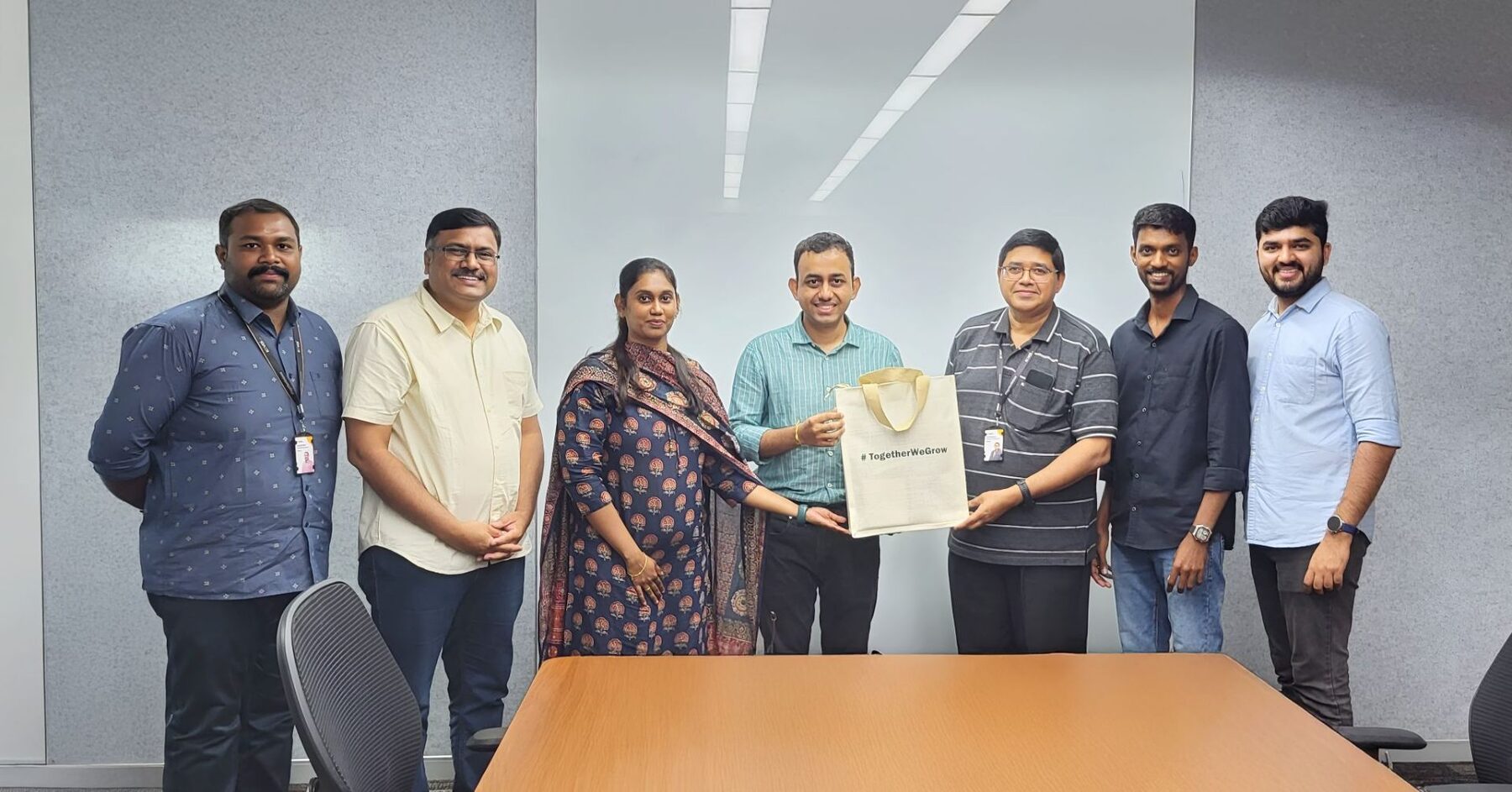 Srivaradha with a client SDR team in Chennai, receiving a #TogetherWeGrow bag at the end of an onsite training engagement.